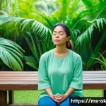 Home 19 하루의 소중함을 느끼는 명상법 - A serene Malaysian woman in modest casual clothing practicing 4-7-8 breathing meditation while sitti...